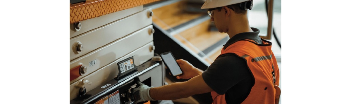 Person operating all-electric scissor lift 