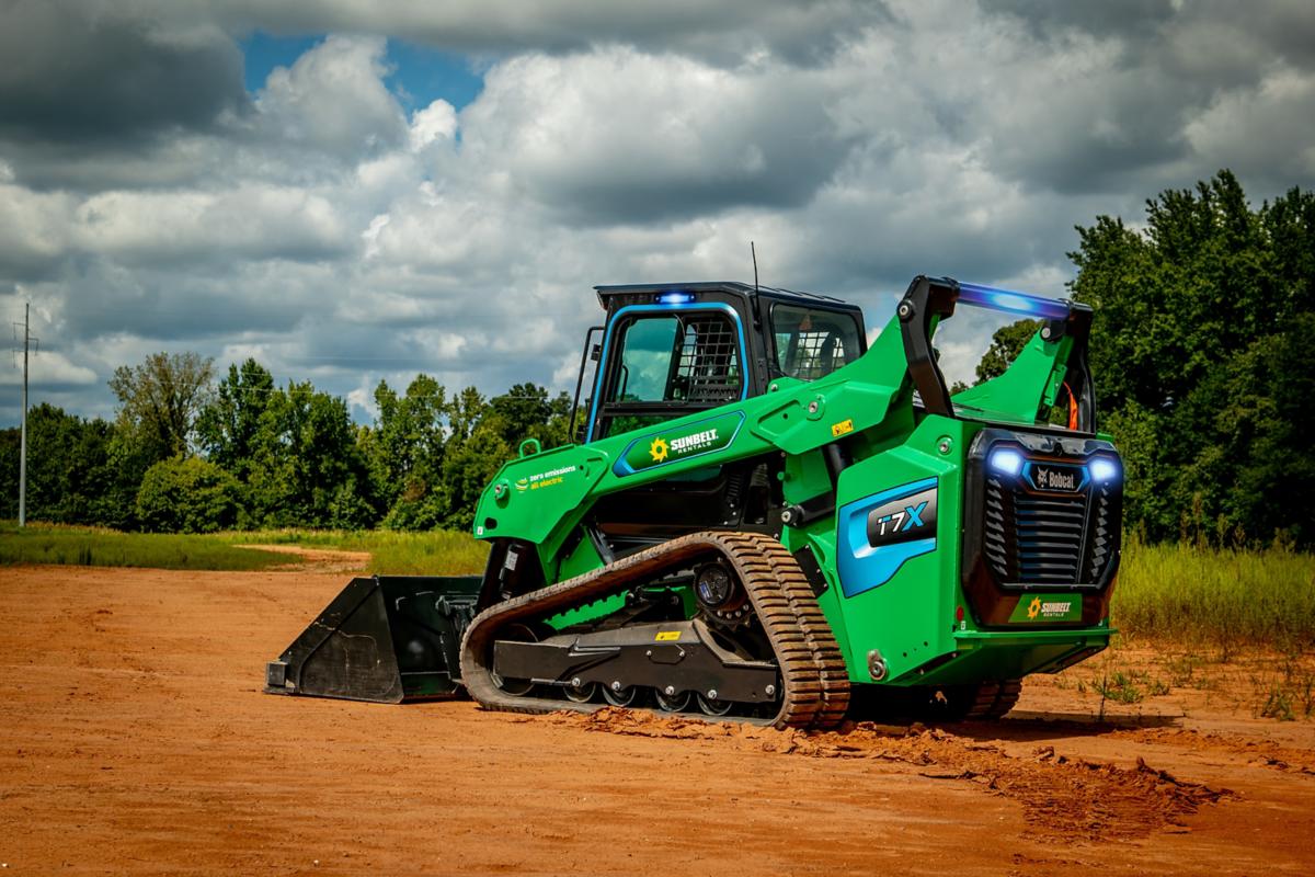  Battery skidsteer sitting in the dirt. 