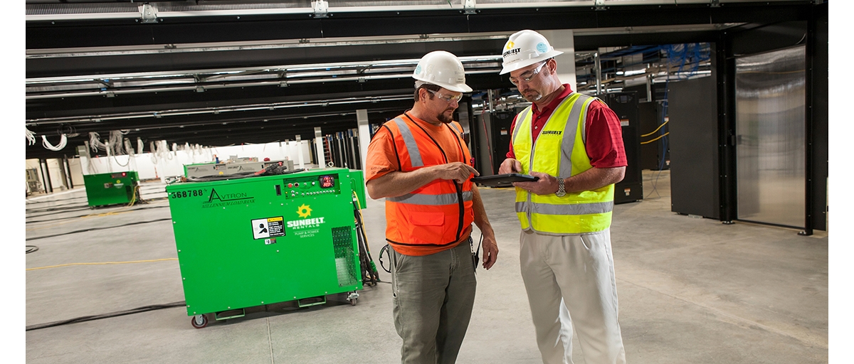 People standing in front of a generator