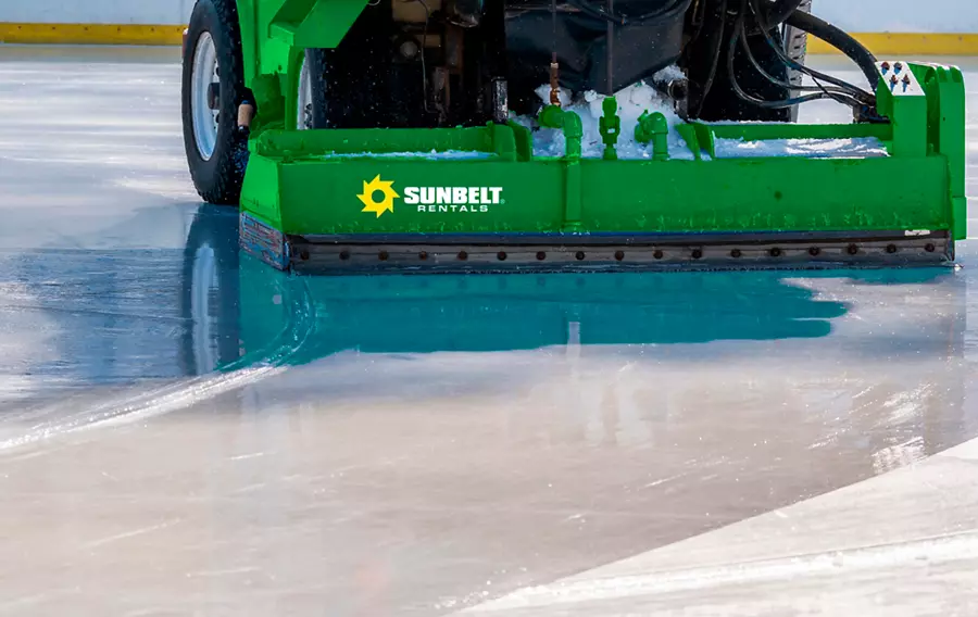 An ice resurfacer smoothing and polishing the surface of the ice rink.