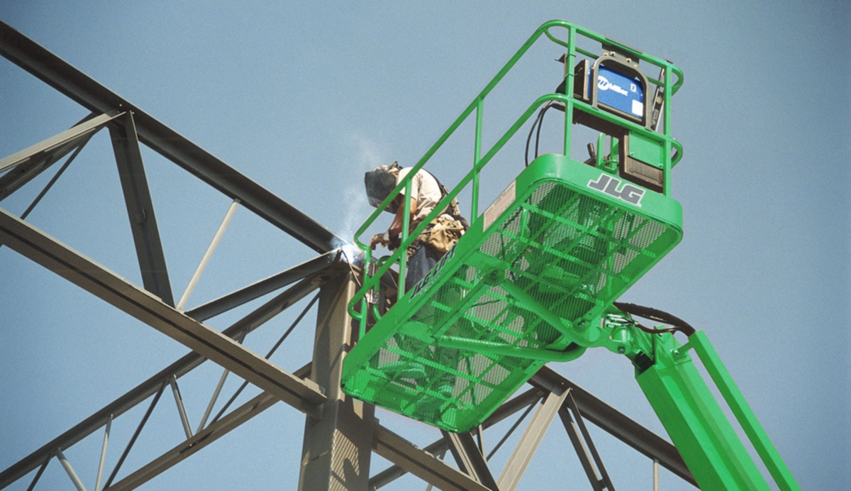 A close-up view of someone welding from a manlift.