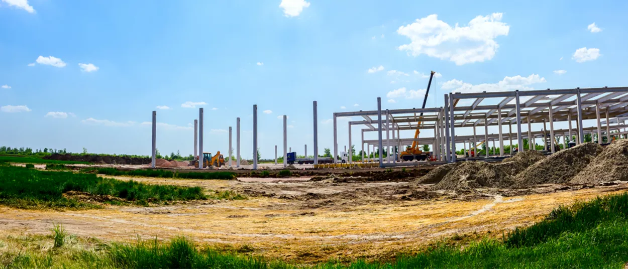 A construction site with the beginnings of a building's framework.