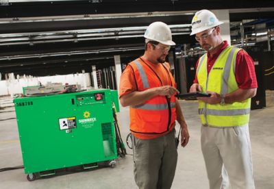 People standing in front of a generator.