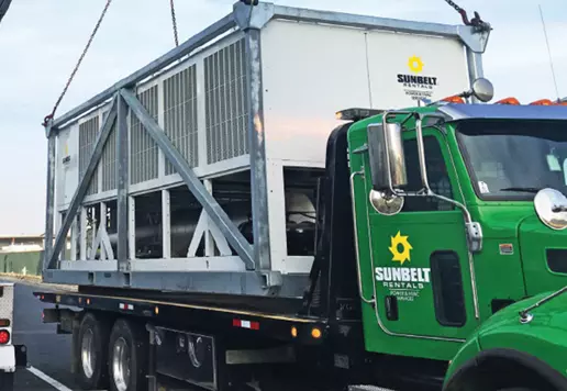 Sunbelt Rentals cooling unit being offloaded from flatbed a truck