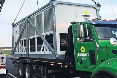 Sunbelt Rentals cooling unit being offloaded from flatbed a truck