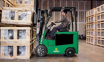 Worker using Sunbelt Rentals Forklift to load truck bed