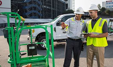 Sunbelt worker training trainee about fall protection for lift