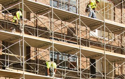 Construction workers working on scaffolds