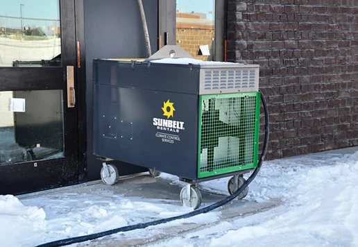 A direct-fired heater from Sunbelt Rentals installed at a school building.