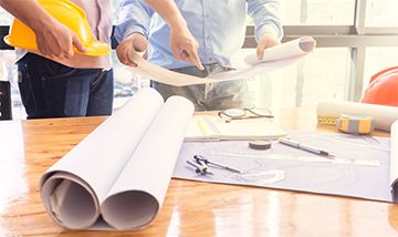 Construction Managers around the table planning a project