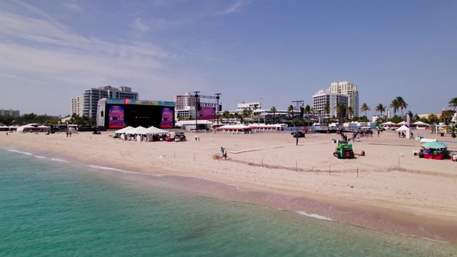 A sunbelt rentals telehandler parked on the beach. 