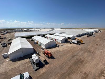 An aerial view of temporary structures built across extensive land.