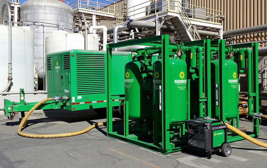 Air compressors from Sunbelt Rentals in an industrial setting.