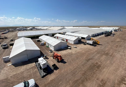 An emergency response base camp set up on a large plot of land.