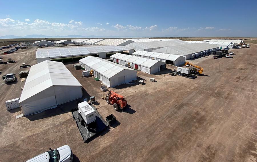 An emergency response base camp set up on a large plot of land.