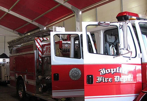 A fire truck parked inside of a temporary structure.