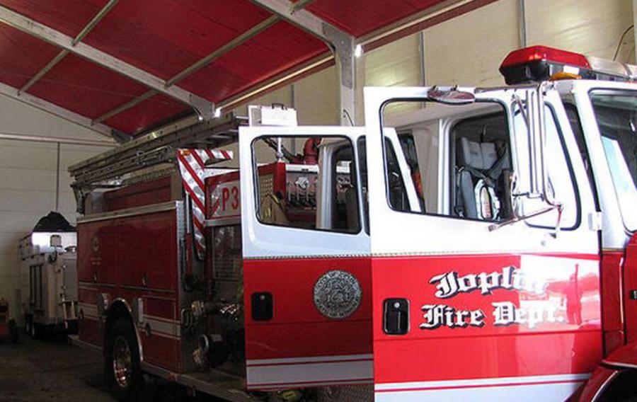 Someone unloading an air scrubber from a Sunbelt Rentals van.