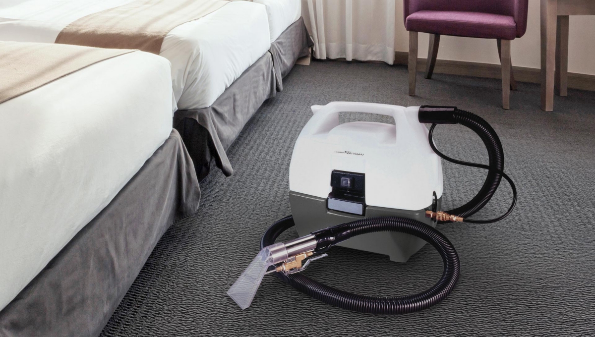 A carpet extractor inside of a hotel room.