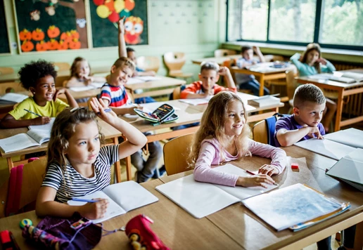 Children sitting in a classroom.