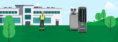 Illustration of two industrial air purifiers placed on a green lawn outside a modern building and a worker in a safety vest emphasizing an industrial setting
