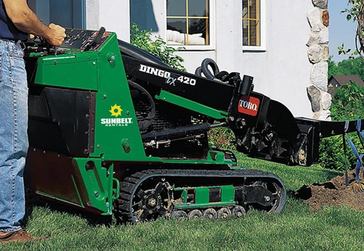 Landscaper operating a compact track loader.