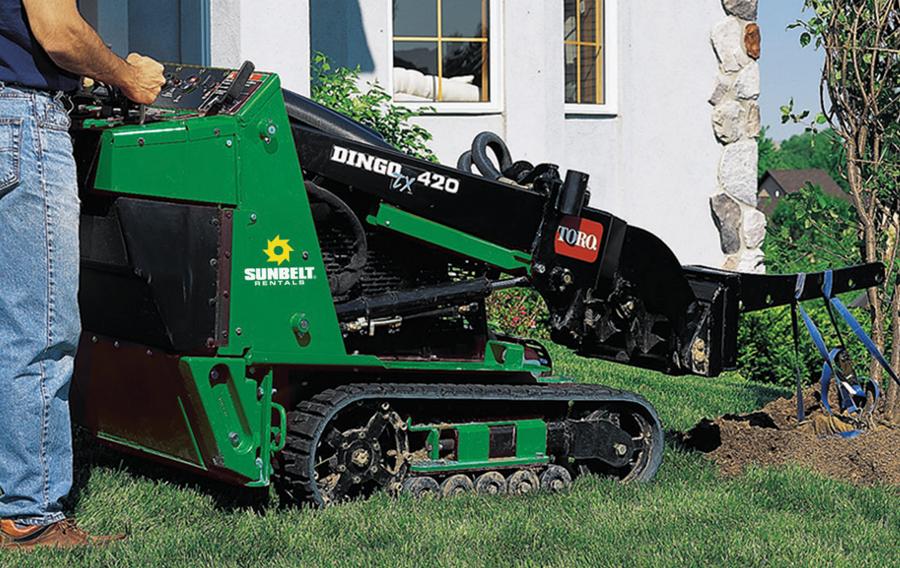 Landscaper operating a compact track loader.