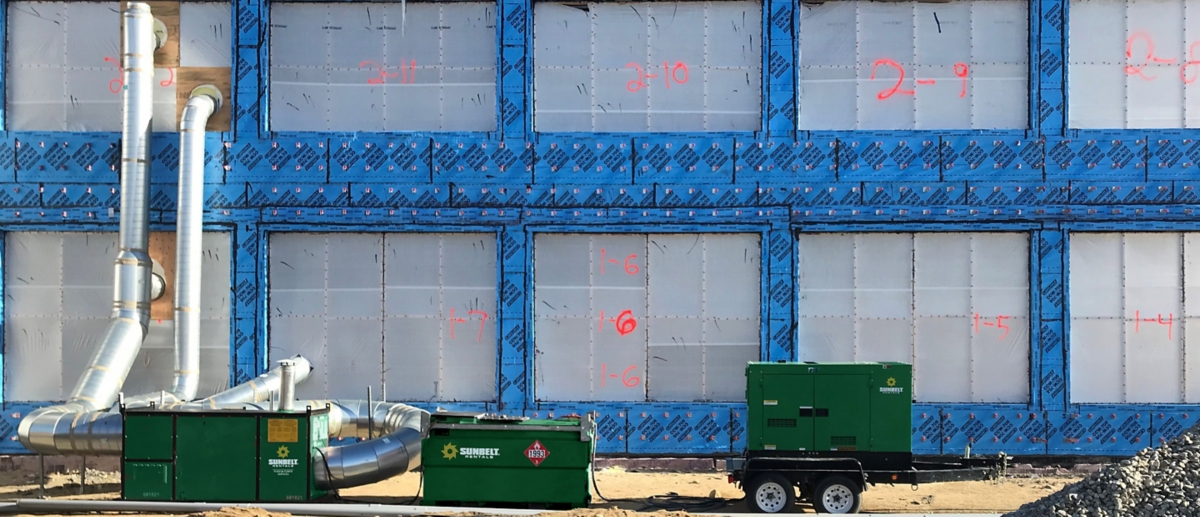 Industrial generators from Sunbelt Rentals at a construction site.