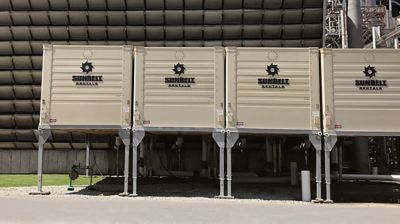 Cooling towers from Sunbelt Rentals set up outside of an industrial facility.