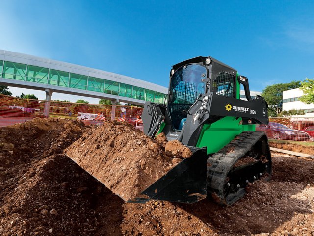 A dozer from Sunbelt Rentals picking up dirt at a construction site.