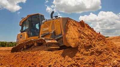 A dozer moving dirt at a job site.