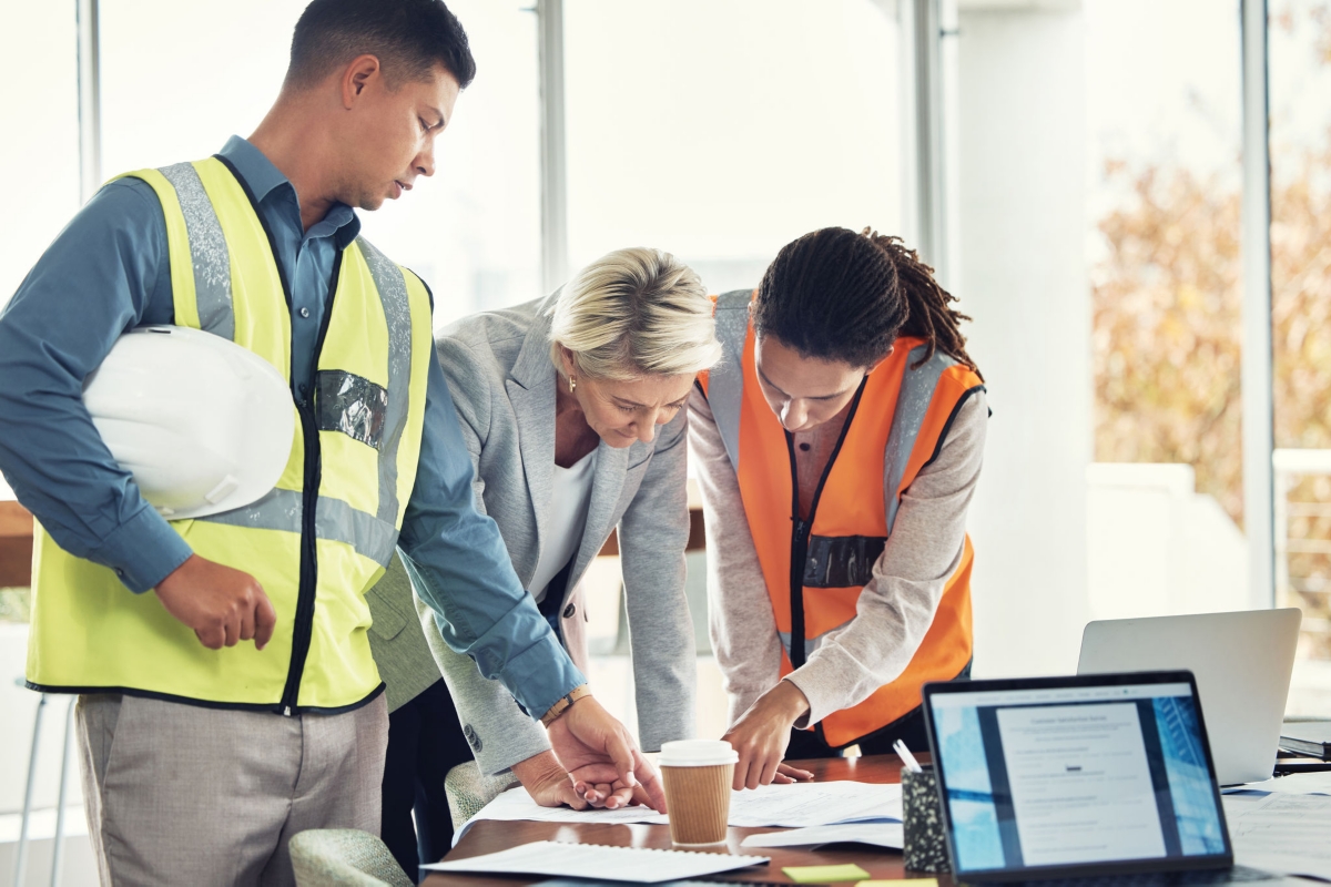 Engineering, teamwork and meeting with people in office for construction, designer and building. Collaboration, review and planning with group in architecture firm for project management and goal