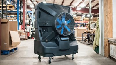 An evaporative cooling fan set up inside of a warehouse.