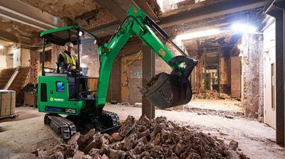 An excavator in a building under construction.