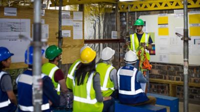 People wearing safety apparel taking a safety training course.