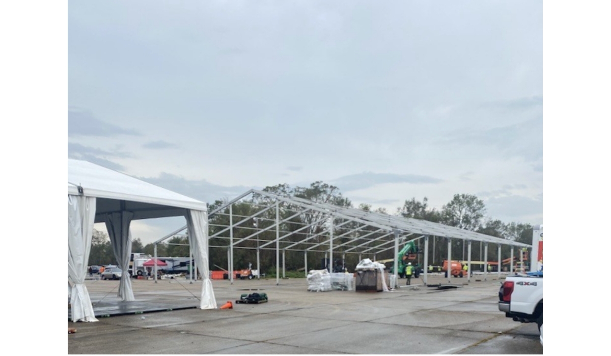 Sunbelt Rentals workers constructing an emergency response base camp in a parking lot.