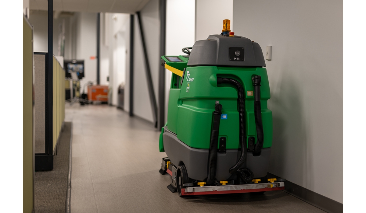 A floor scrubber from Sunbelt Rentals sitting in the hallway of a commercial building.