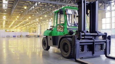 A forklift inside of a large, open building.