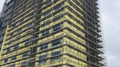 Scaffolding in use on the side of a large multi-story building.