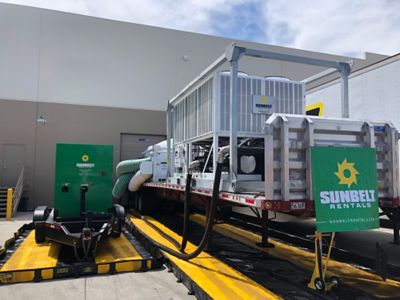 A commercial air conditioning rental unit installed outside of a building.