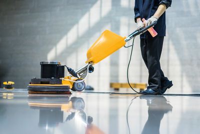 Person using a floor buffer.