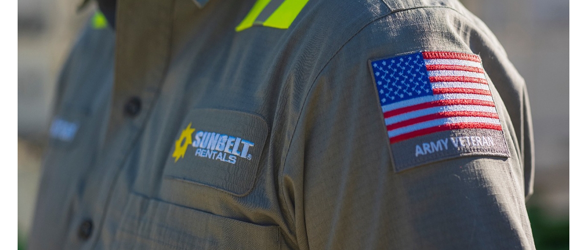 A button down shirt with embroidered Sunbelt Rentals and army veteran patches.