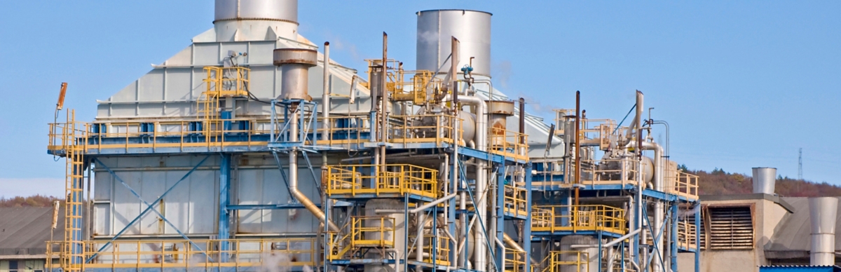 Industrial building with pipes and chimneys