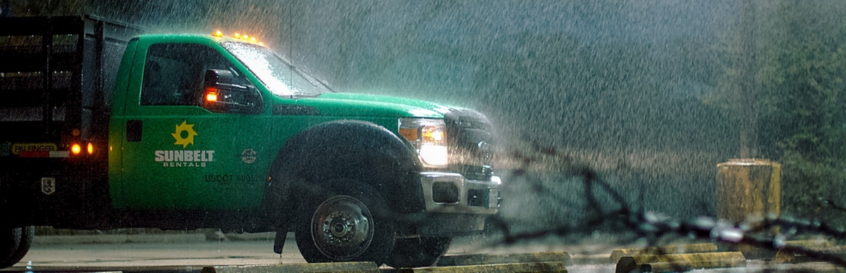 A Sunbelt Rentals truck in stormy weather.