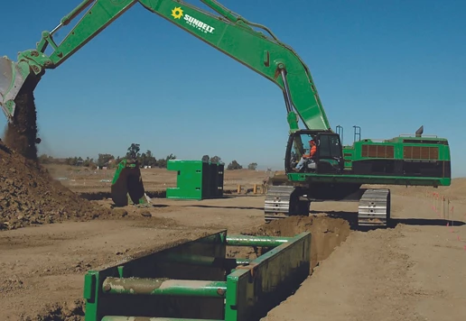 Someone driving an excavator to dig at a construction site.