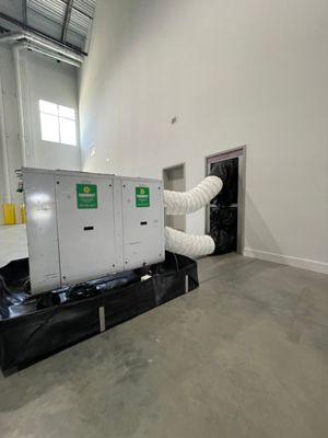 A portable cooler from Sunbelt Rentals installed inside of a building.