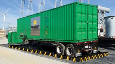 A large generator near wind turbines.