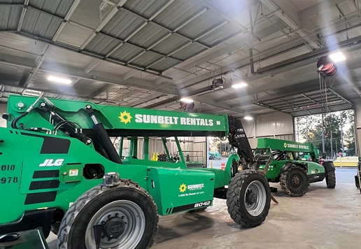 LED lighting inside of a building with forklifts from Sunbelt Rentals inside.