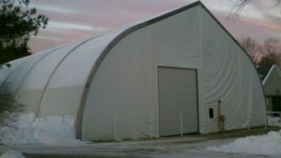 A temporary warehouse outside during the winter.