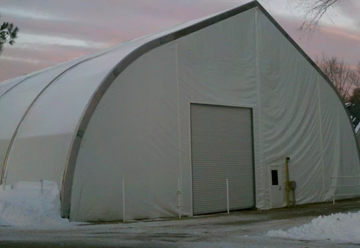 A temporary warehouse outside during the winter.