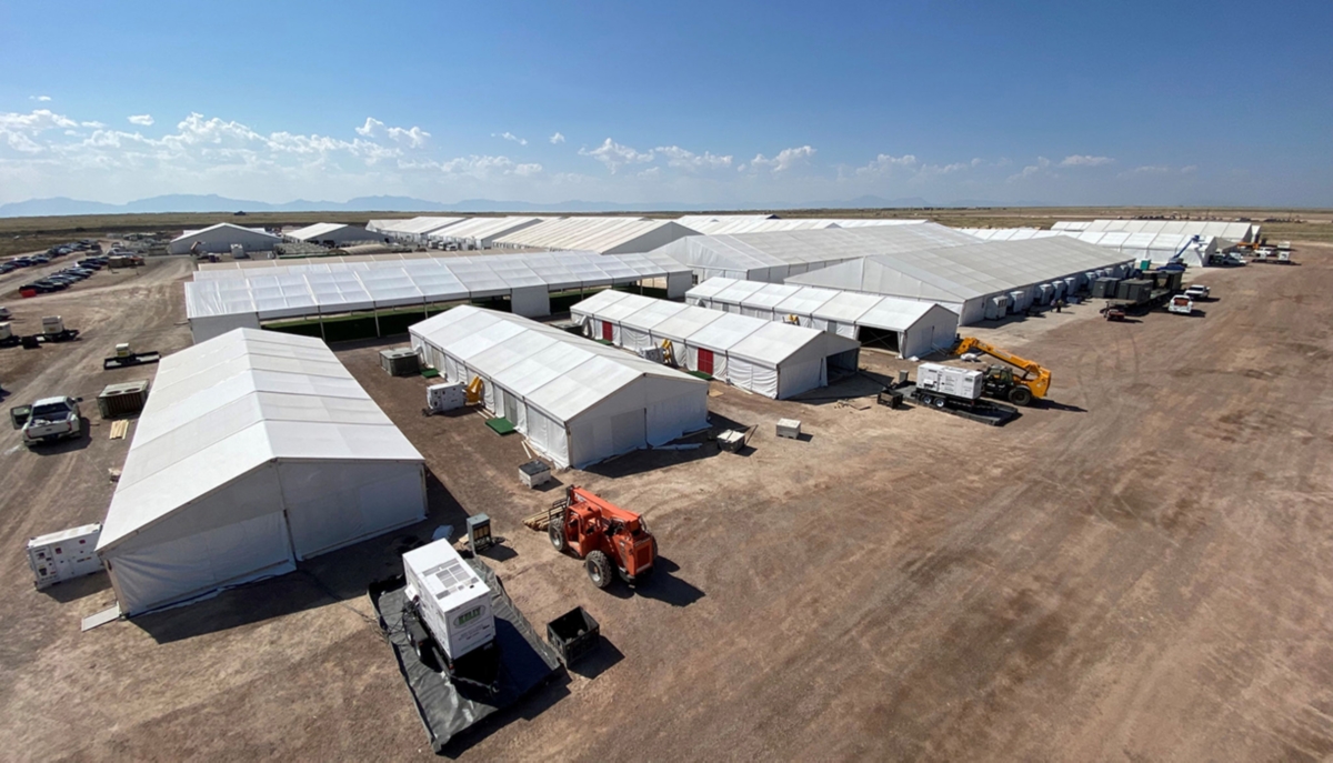 An emergency response base camp set up on a large plot of land.